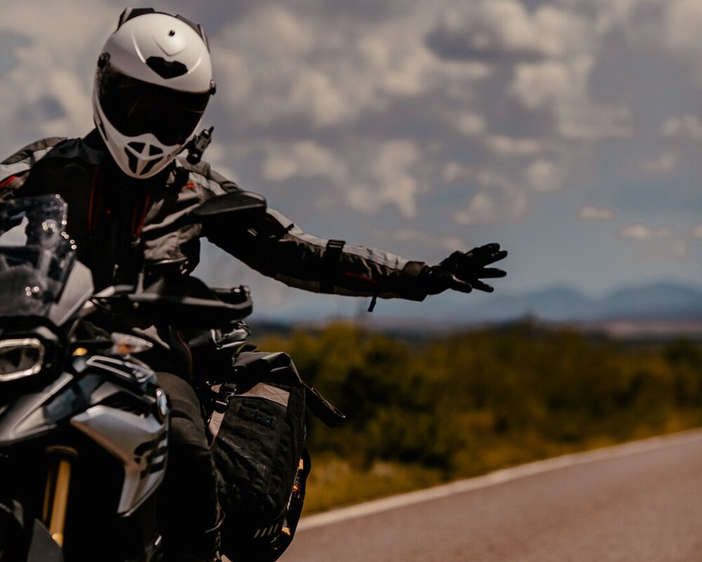 Woman riding adventure motorcycle with helmet and Sena