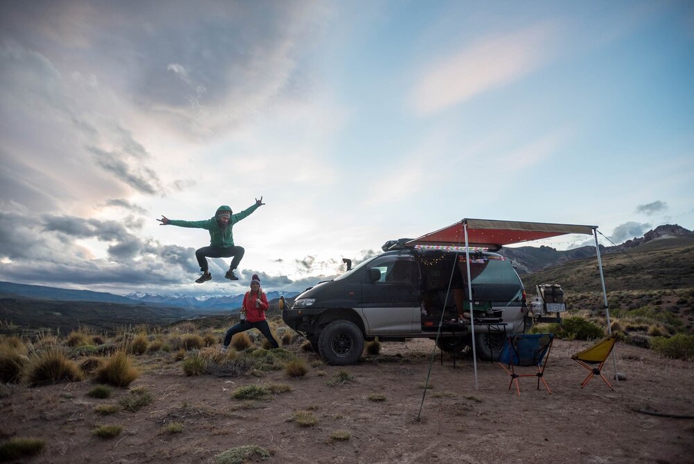 Man and woman taking a silly photo at camp in the desert.