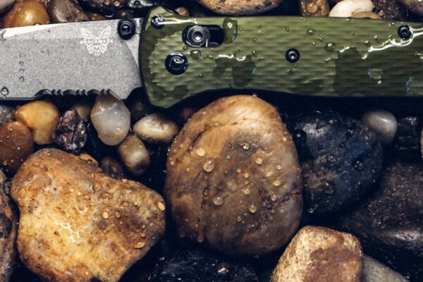 Benchmade knife near a river bank.