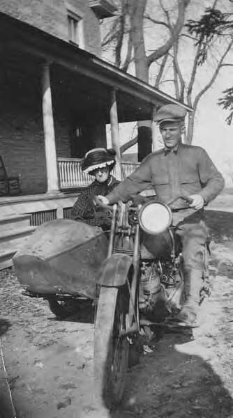 Man_on_motorcycle_with_woman_in_sidecar,_location_unknown,_1921_(INDOCC_793).jpg