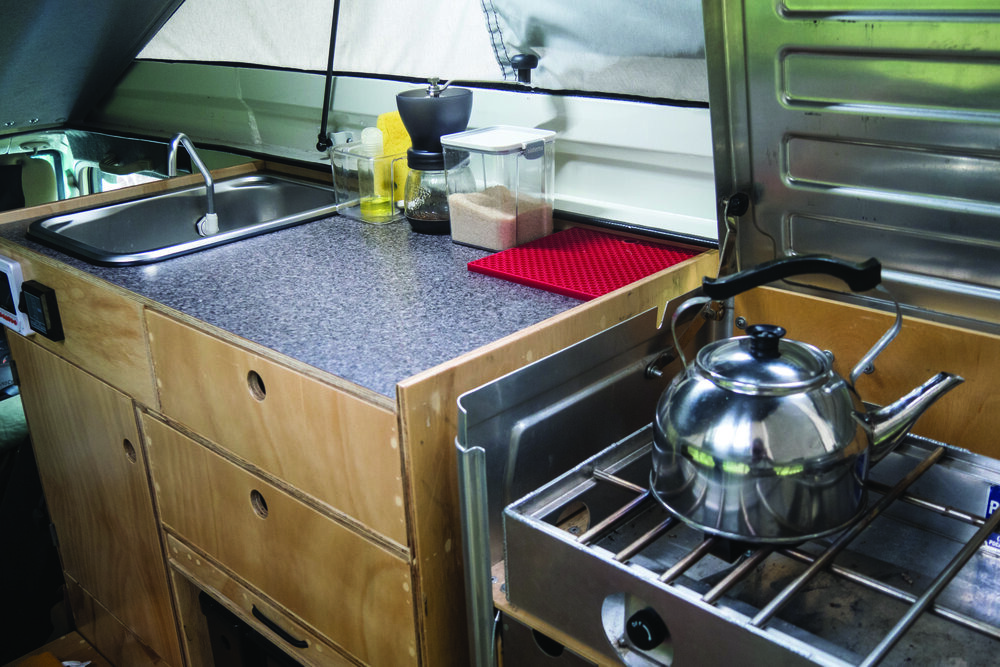  Partner Steel propane stove, counter, and sink with pressure-fed faucet. | Photo: Jonathan and Roseann Hanson 