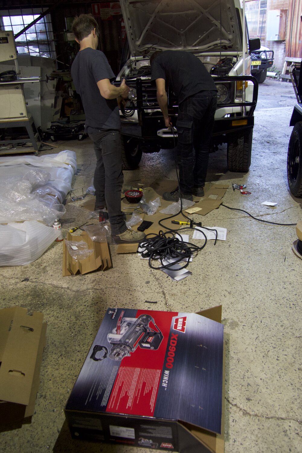  Daniel and an assistant installing the Warn XD9000 winch. | Jonathan Hanson 