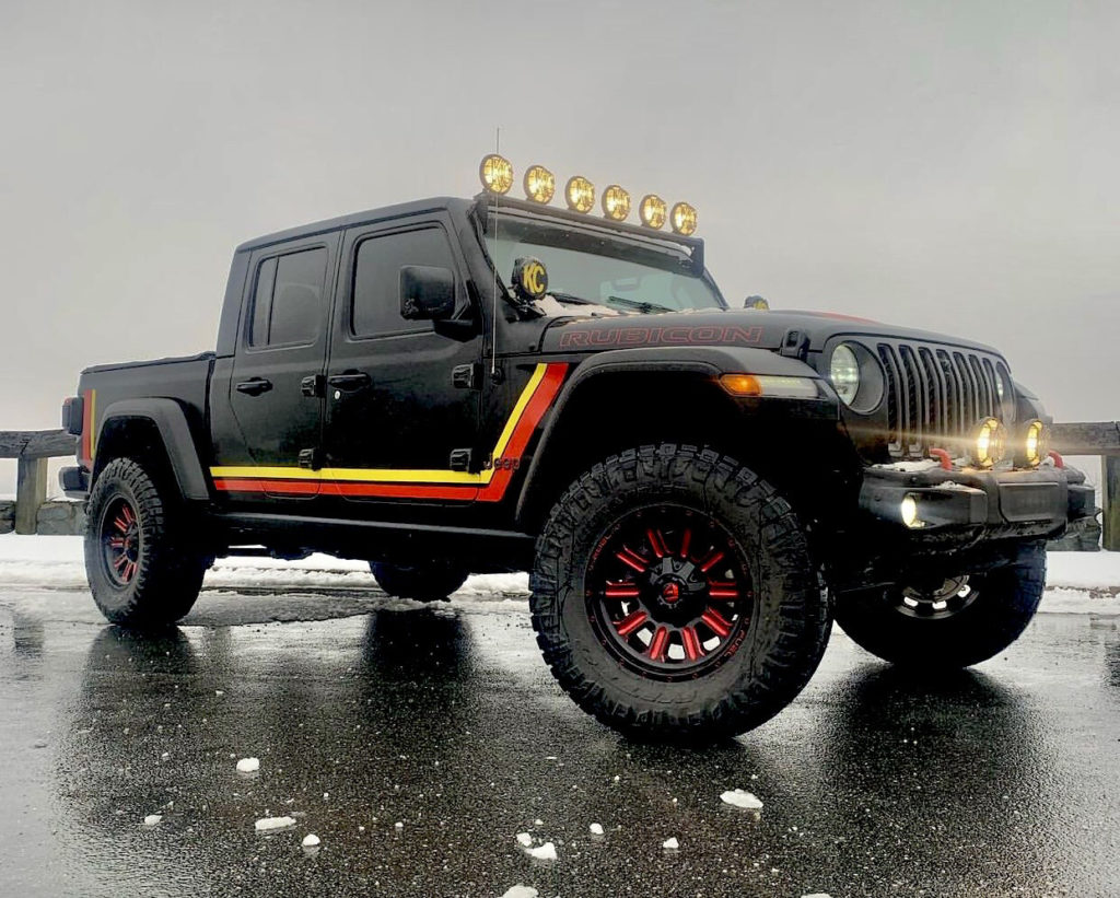 A Jeep Gladiator with retro style Scrambler graphics.