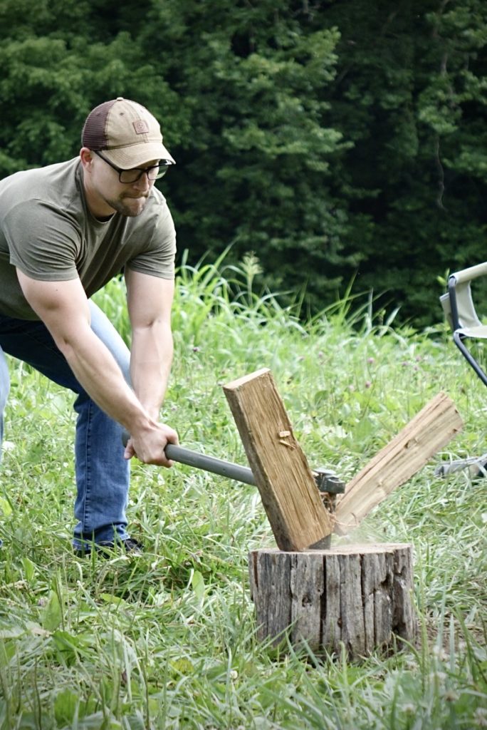 A man splitting wood with the Max Tool kit