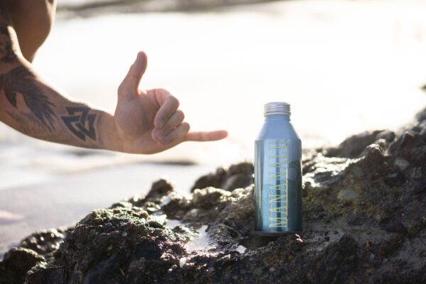 Mananalu Metal Water Bottle on volcanic rocks.