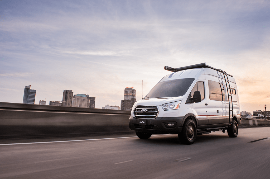 Storyteller Overland MODE LT rolling down the highway in a cityscape.