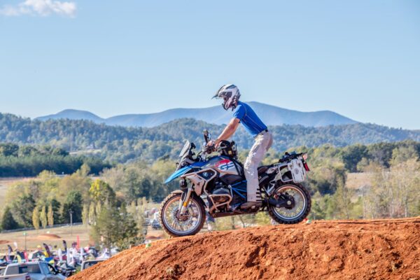Motorcyclist crossing a dirt berm