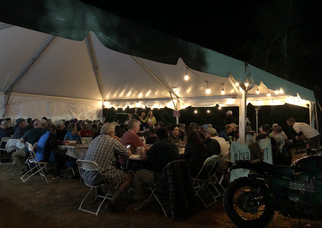 Motorcyclists at Overland Expo East winning prizes at the Moto Dinner