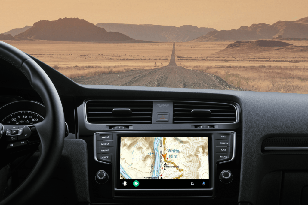 Backcountry map on Android Auto on the nav screen of a vehicle with dirt road in the distance.