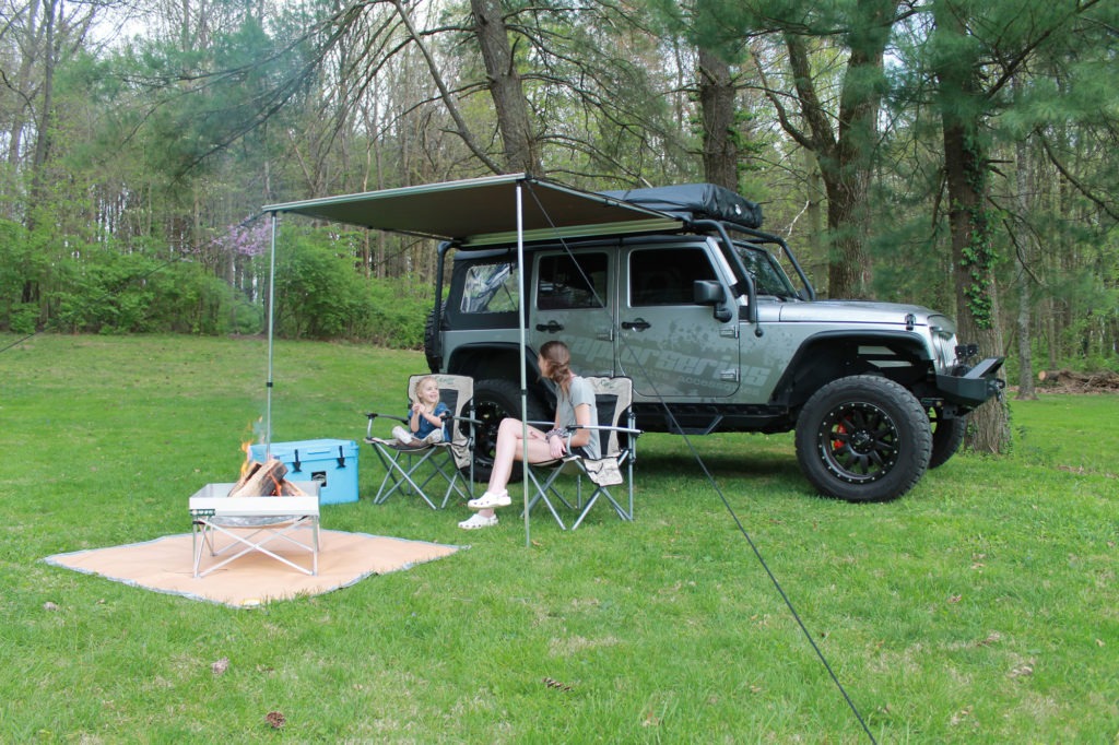 Jeep with awning set up for a picnic.