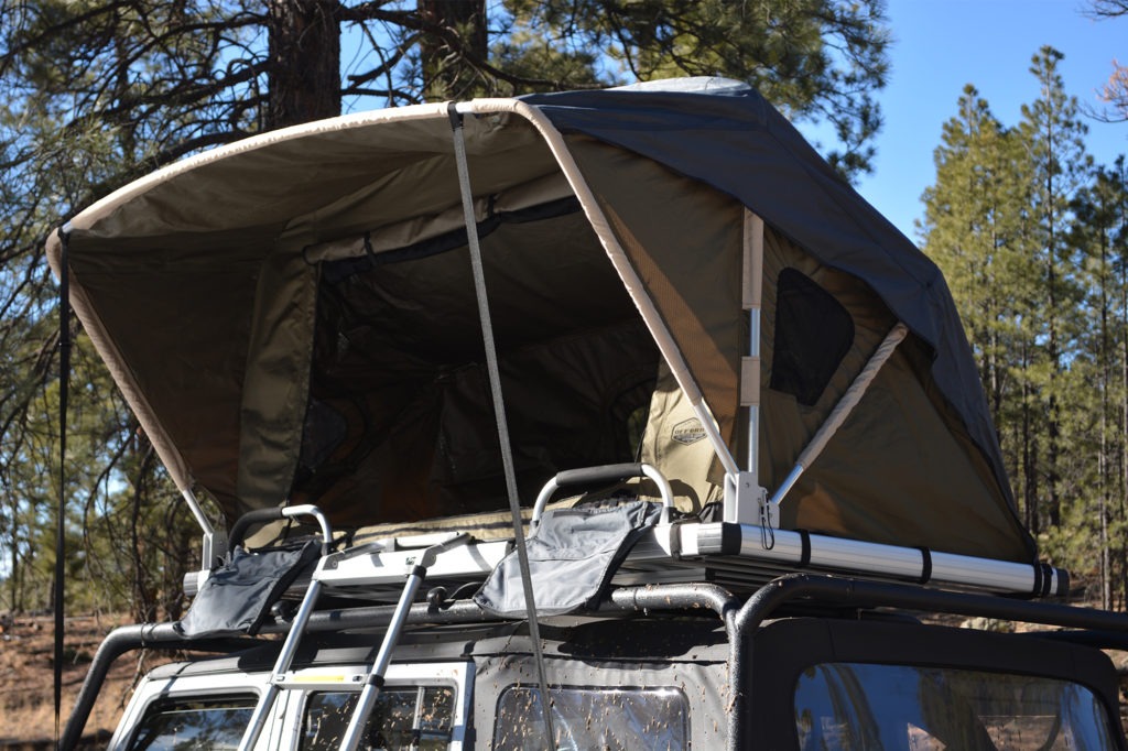 Roof top tent deployed on a Jeep.