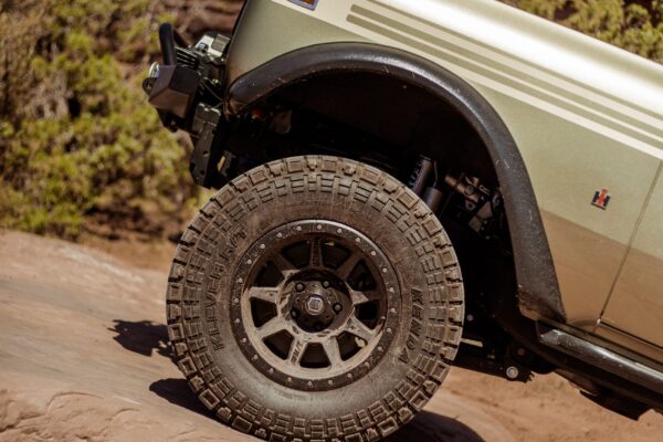 Close up of an International Scout's front tire on a rocky ledge.