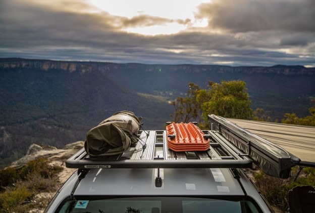 Close up of a roof rack with sunset in the distance.