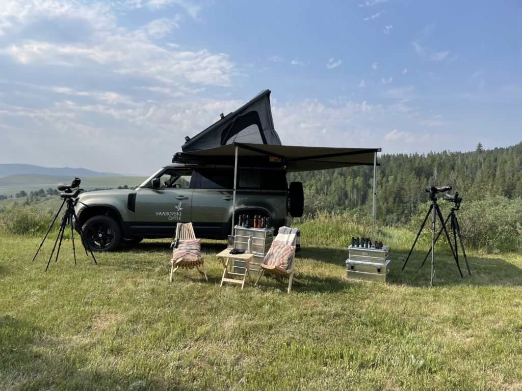 A Defender with awning and rooftop tent.