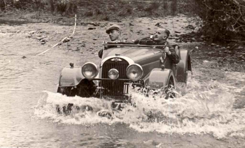 Vintage photo of a Morgan crossing a stream.