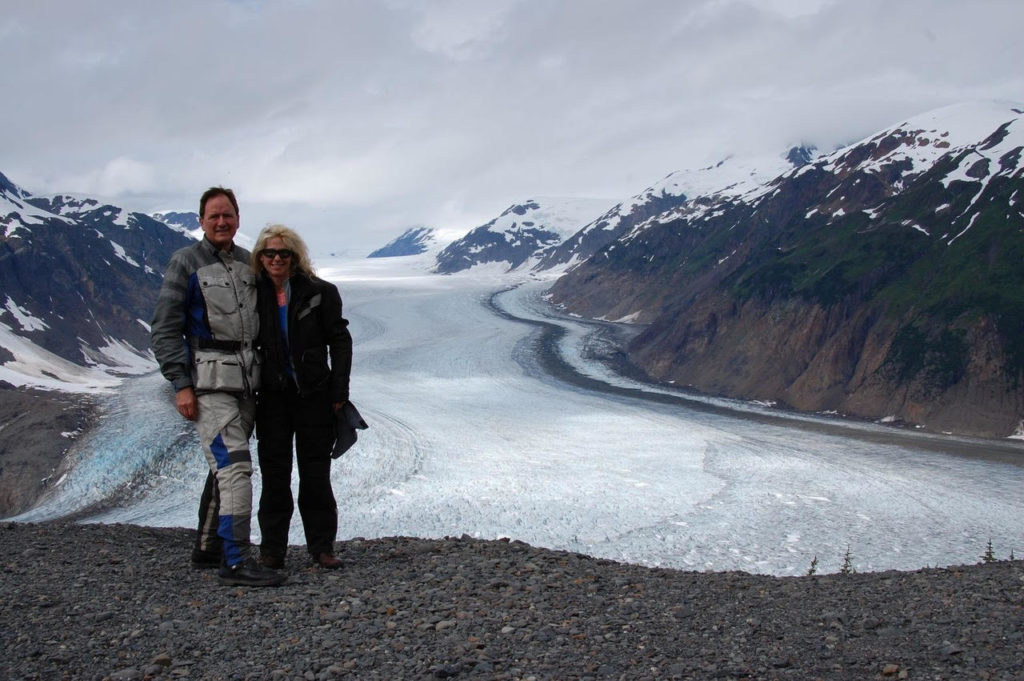 Moto tourers posing in front of glacier field.