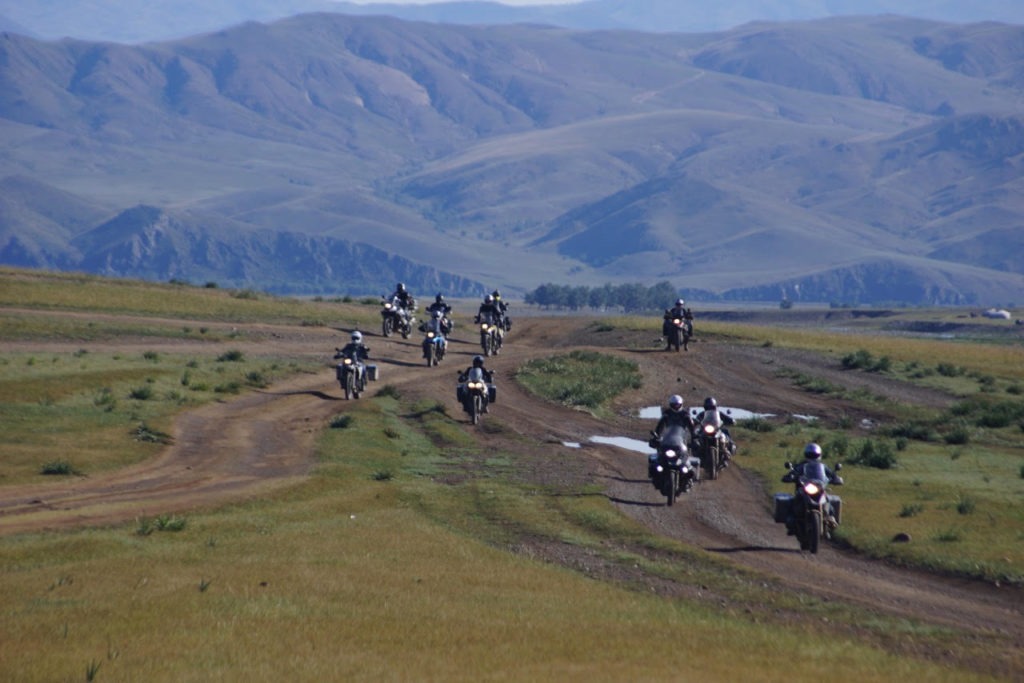 Moto tourers on a dirt road. 