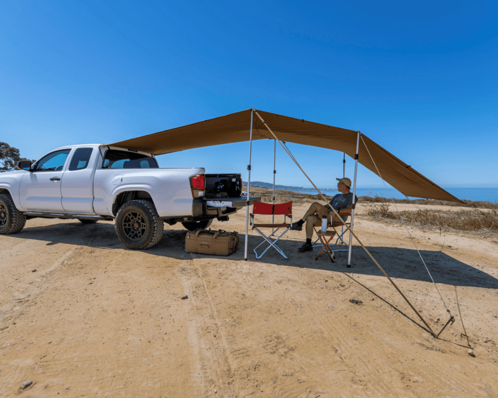 Tarp set up behind a Tacoma.