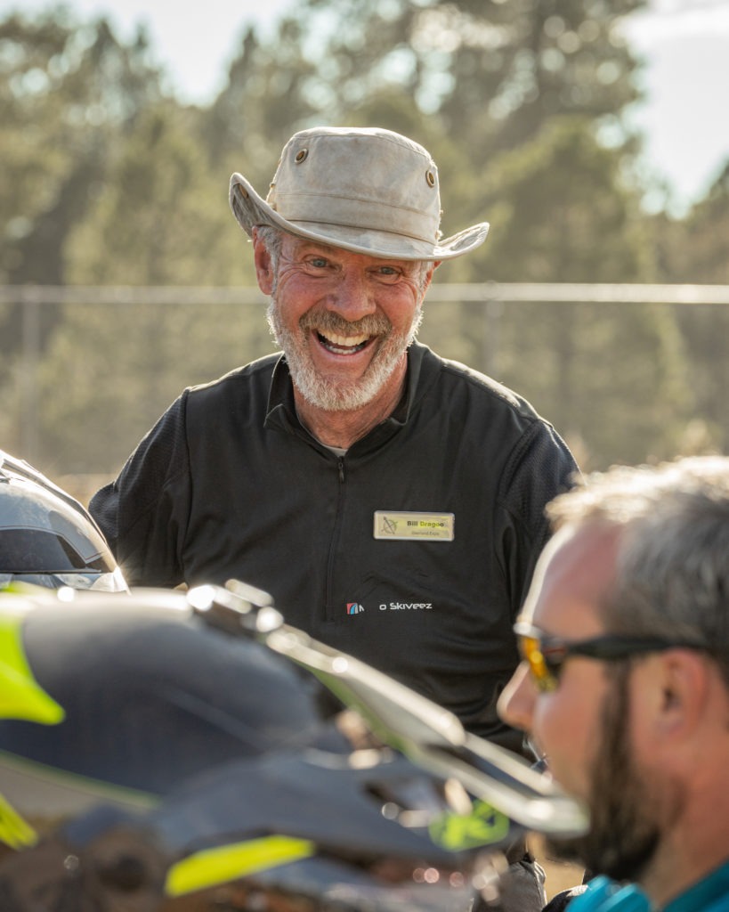 Man laughing while teaching motorcycle skills.