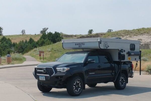 BundutecUSA Topi Truck Camper parked at a rest stop.