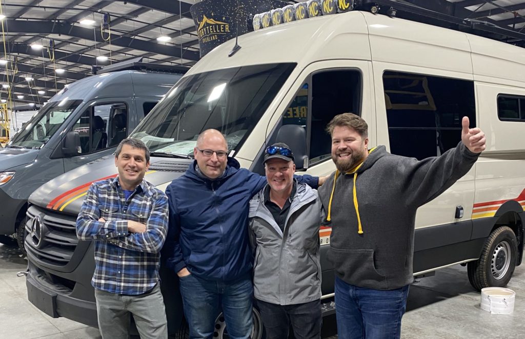 Storyteller Overland team congratulating man who is picking up his van from the factory.