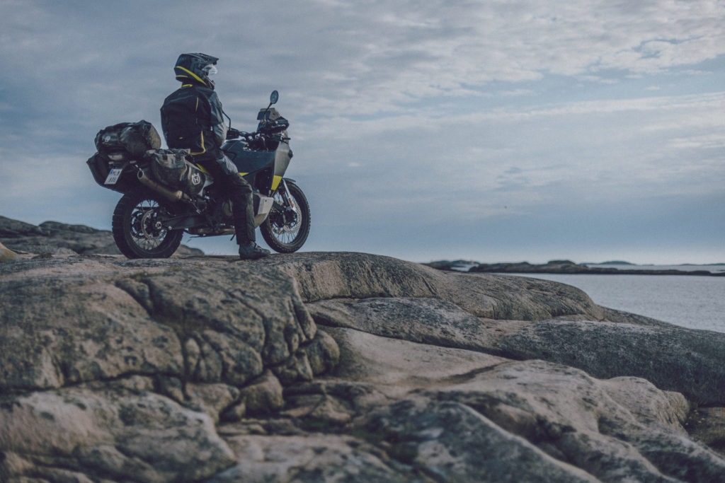 Husqvarna Norden 901 motorcycle parked on the rocks by the water