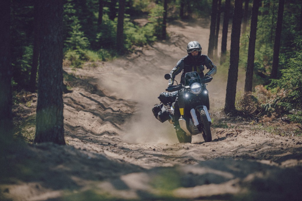 Husqvarna Norden 901 motorcycle riding on a sandy dirt trail