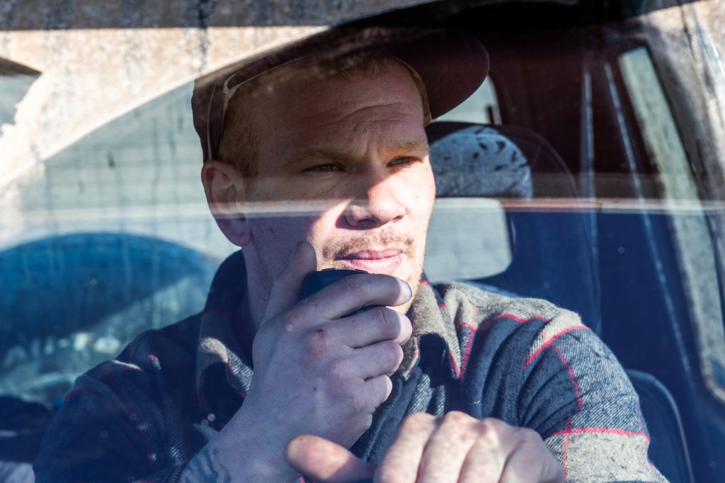 Man sitting in truck on a Midland Radio