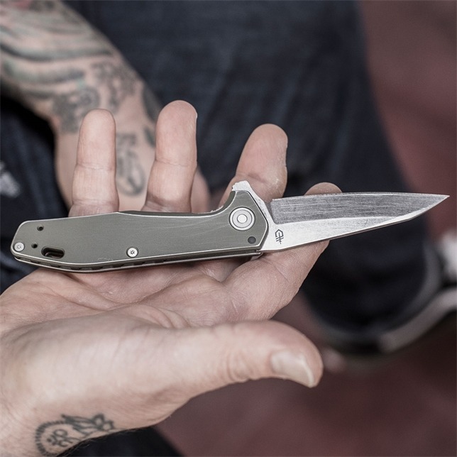 Close up of a man holding a Gerber Gear Fastball Folder knife.