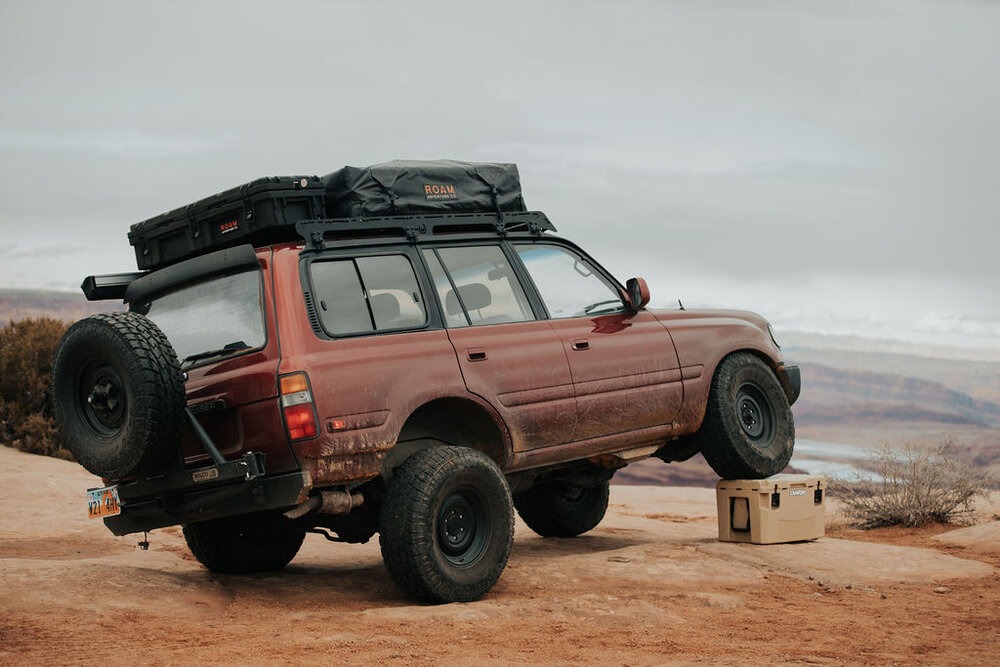 Stress testing a Canyon Coolers Cooler by driving a vehicle over it.