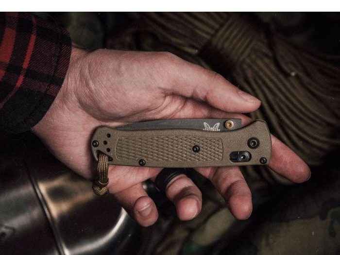 Close up of a man holding a Benchmade Bugout DP knife.