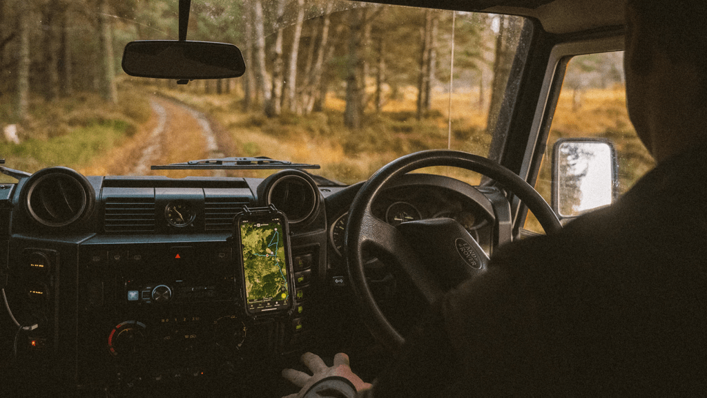 Man driving a Land Rover offroad while 