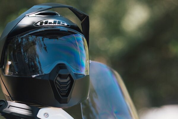 HJC C80 Bult Adventure helmet sitting on the handlebars of a motorcycle.