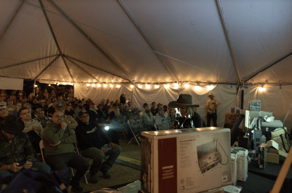 People enjoying the Overland Expo Foundation Raffle in the FieldCraft Survival Theater.