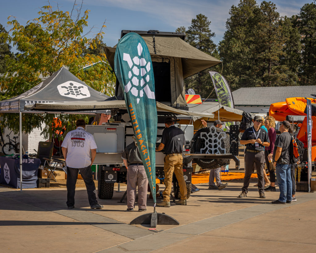 Attendees checking out Turtleback Trailers at Overland Expo WEST.
