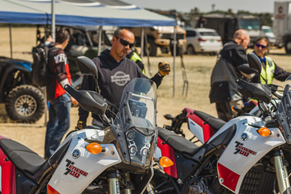 Attendees at Overland Expo with motorcycles