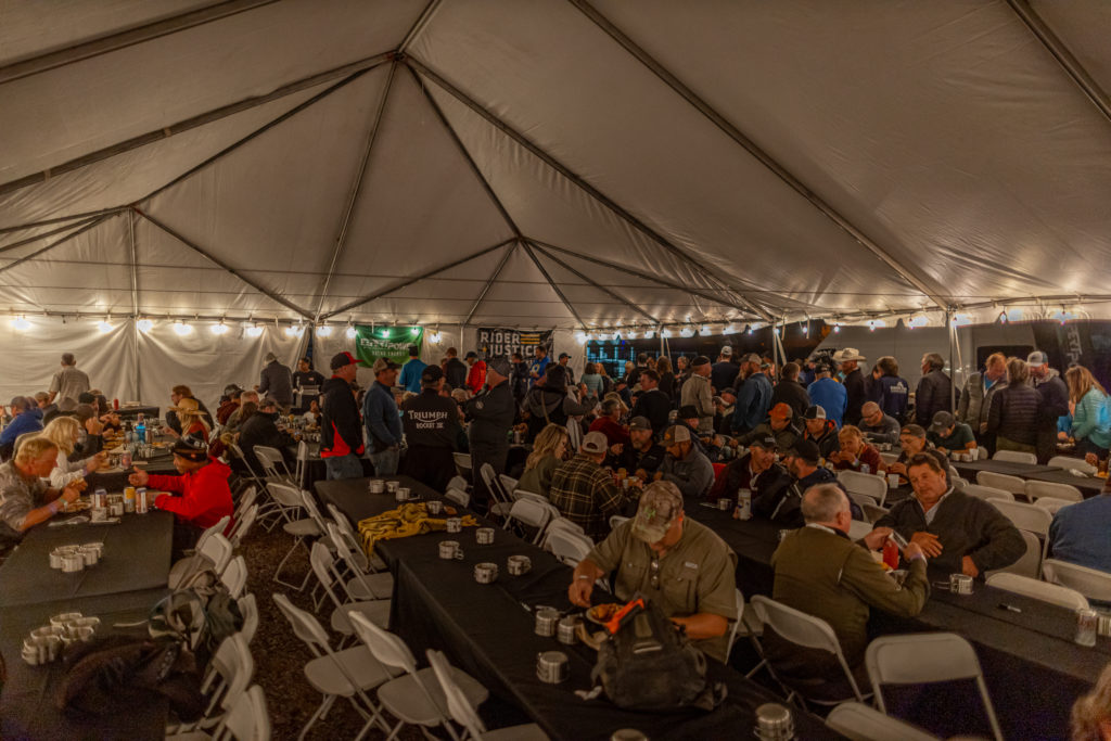 People enjoying the dinner and drinks at the Overland Expo Moto Party at Overland Expo WEST.