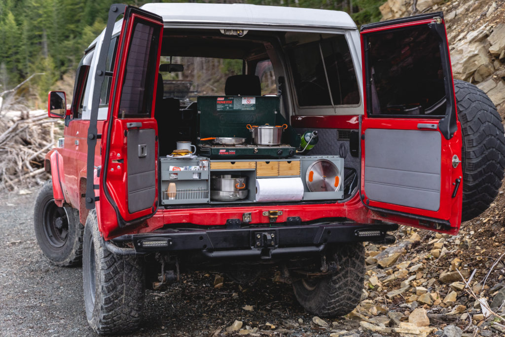 Green Goat Outdoors Camp Kitchen open in the back of a Land Cruiser