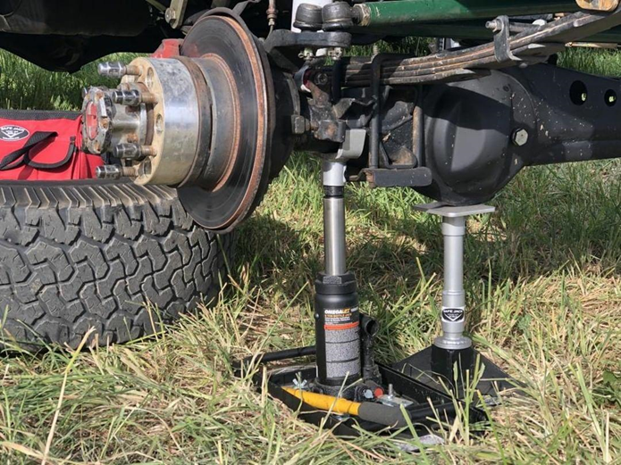 Vehicle safely lifted using the Safe Jack "The Sergeant" Off-Road Kit bottle jack.