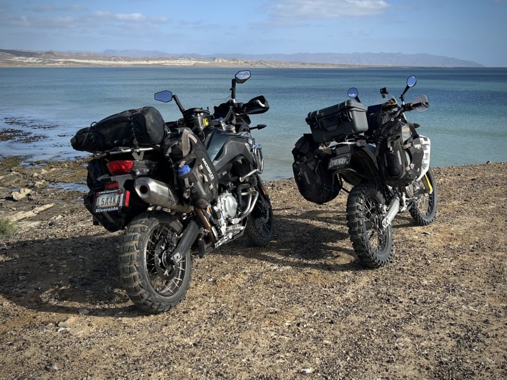 Two motorcycles parked on a beach in Baja