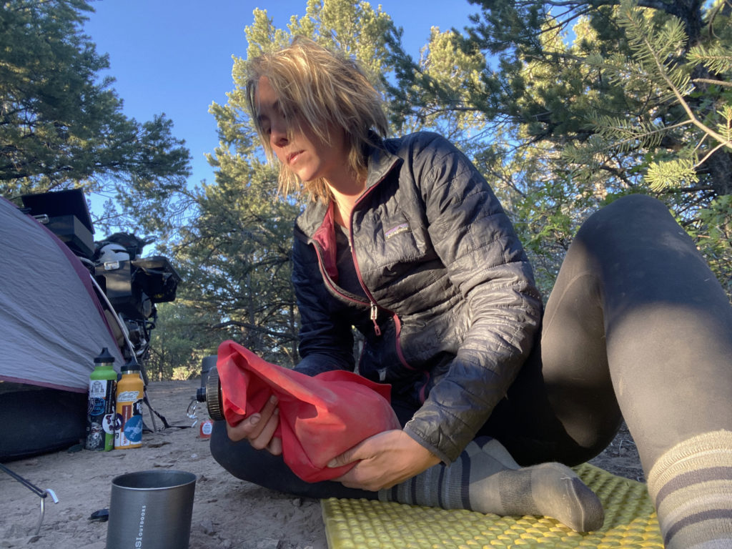 Woman using water bladder at camp