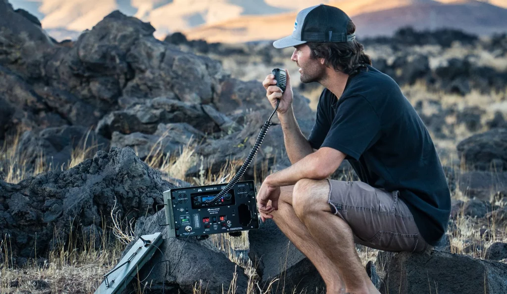 Man using the MXPW Base Station in the backcountry.