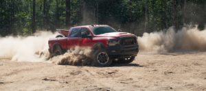 The 2023 Ram 2500 Heavy Duty Rebel kicking up some dust on an offroad track.