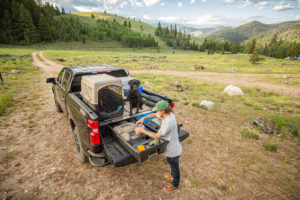 Man accessing his DECKED Drawer System in the backcountry.