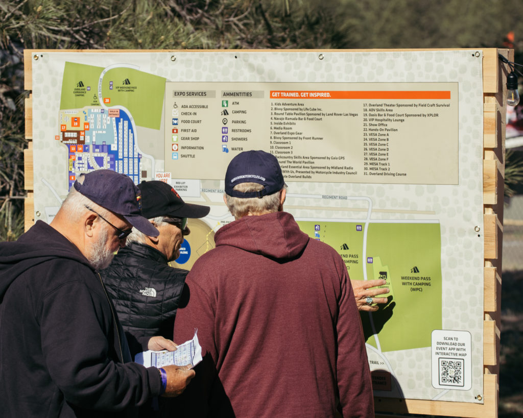 Men checking a map at Overland Expo