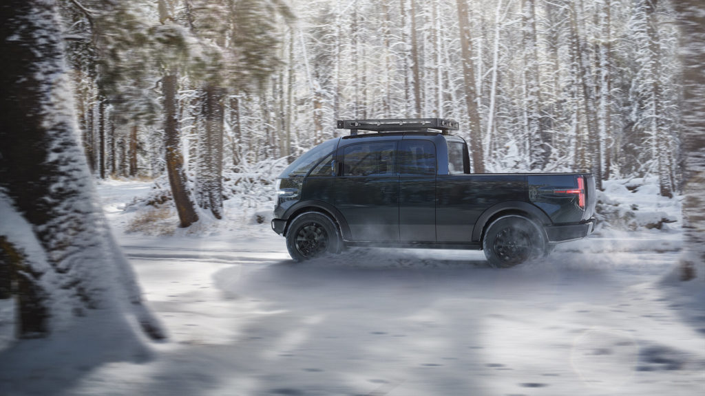 Canoo Pickup Truck driving through the snow.