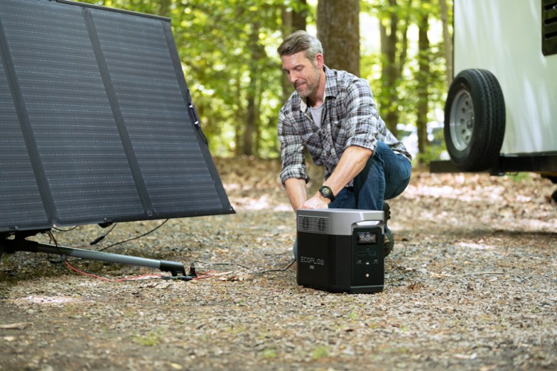 Man using an EcoFlow DELTA Max Portable Power Station to collect solar energy.