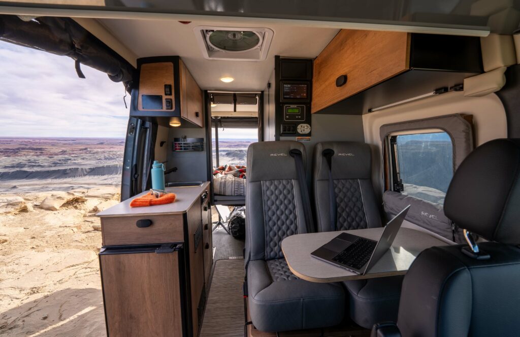 Winnebago Revel camper van interior showing counter space and rear seating.