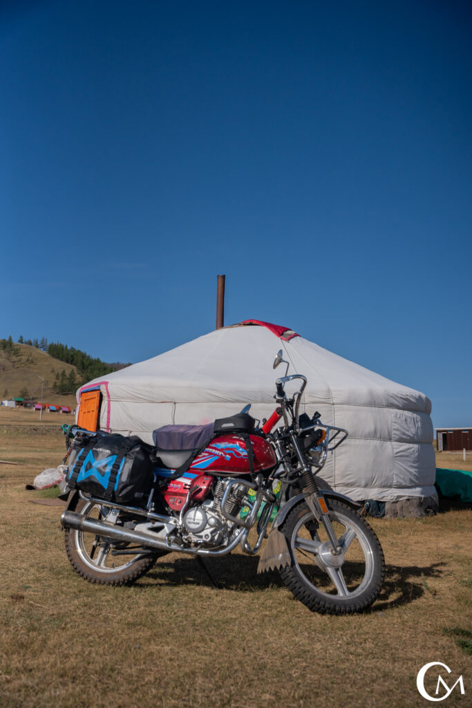 adventure moto photographer Chris McCormack photographs his bike outside a yurt